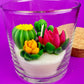 WicksNWax cactus art candle with tall pink tulip-style wax and green cactus in clear glass