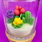 WicksNWax cactus art candle in clear glass with red, green, purple, and yellow cactus wax