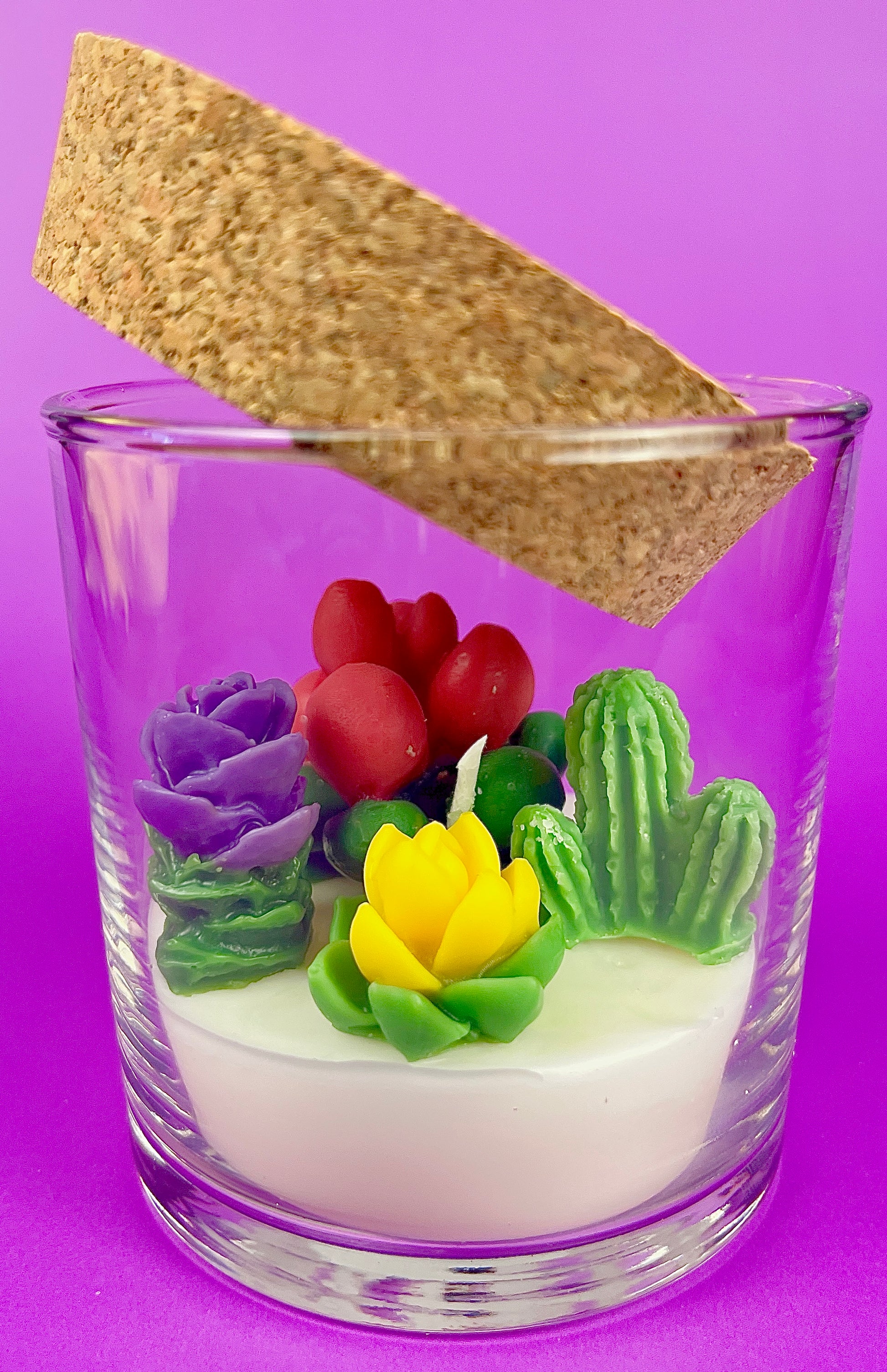 Small cactus art candle with cork lid; clear glass with colorful cactus flower wax