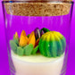 Small cactus art candle with cork lid; clear glass with green and yellow cactus wax