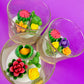 Small cactus art candle in glass jar with red, yellow and green flower wax details