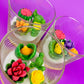 Small cactus art candle with green cactus and bright flower-shaped wax pieces
