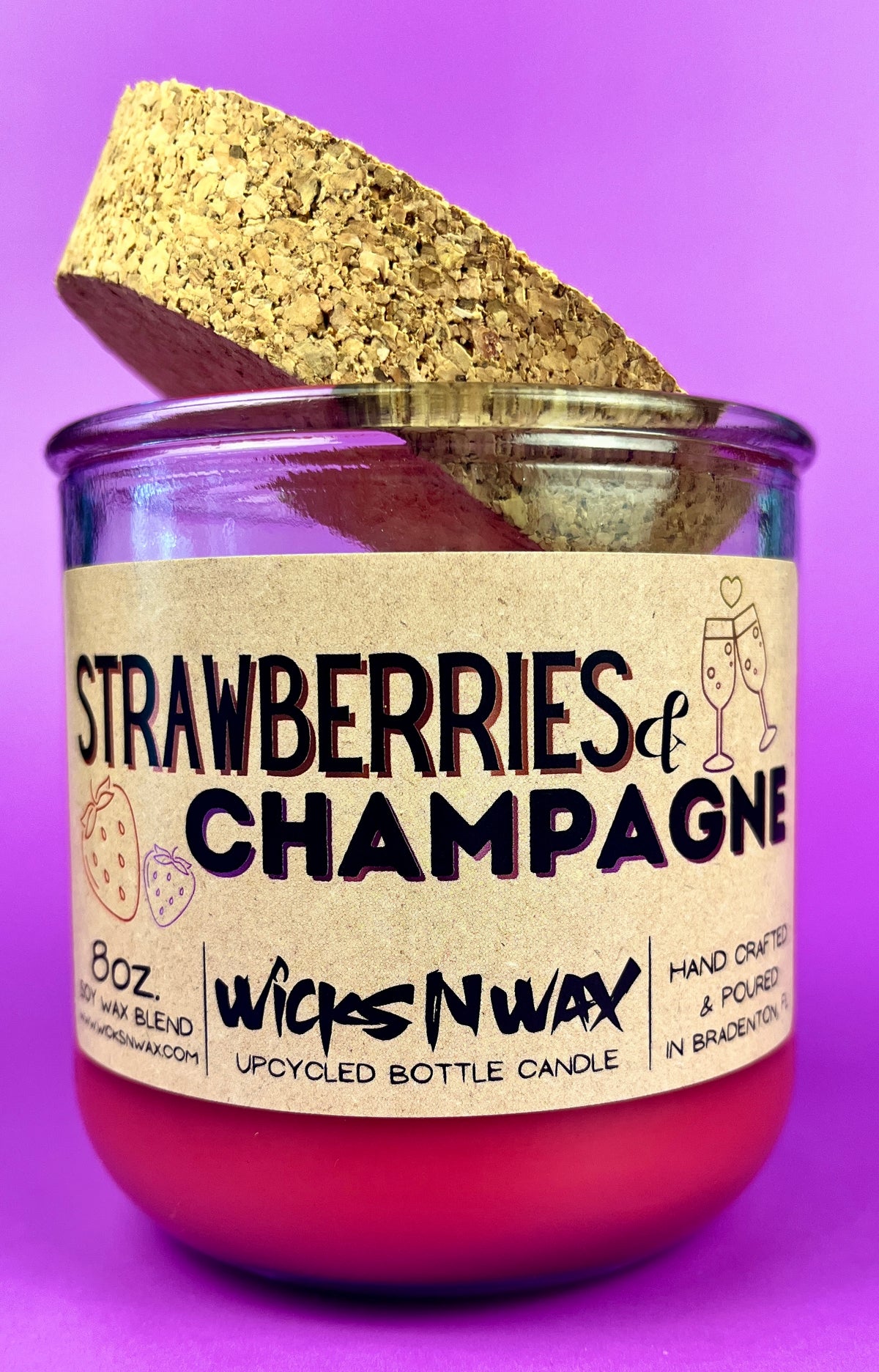 Recycled glass candle with cork base and cork piece, red wax, 'Strawberries & Champagne'.