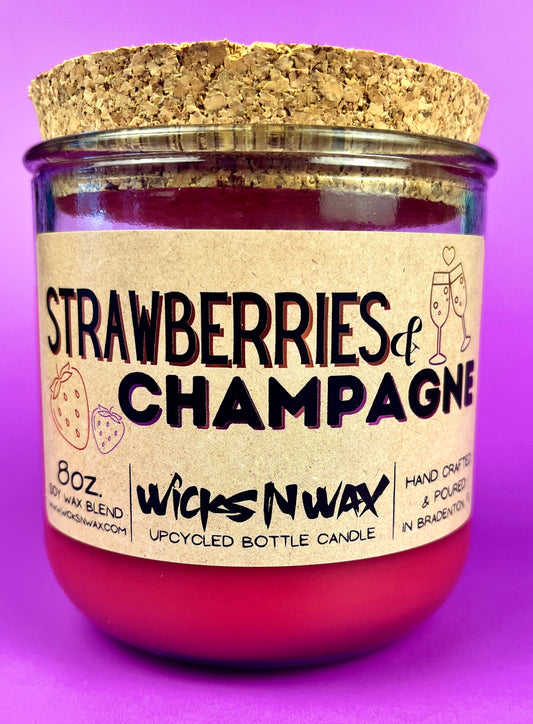 Recycled glass candle jar with red wax, 'Strawberries & Champagne' front label.