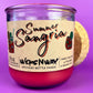 Recycled bottle candle in red wax with clear glass jar and printed label front