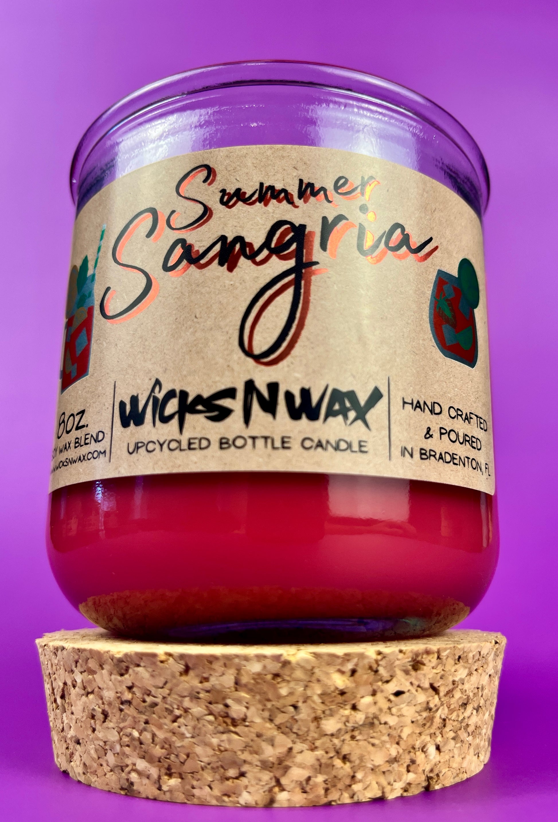 Recycled bottle candle in red wax with clear glass jar and cork base