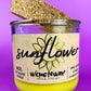 Recycled glass candle with sunflower label and yellow wax, cork lid tilted
