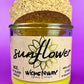 Recycled glass candle with sunflower label, yellow wax, and cork lid