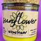 Recycled glass candle with sunflower label, yellow jar, and cork lid, WicksNWax