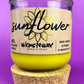 Recycled glass candle with sunflower label on beige wrap and yellow wax