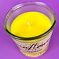 Recycled glass candle close-up of yellow wax and wick in clear jar