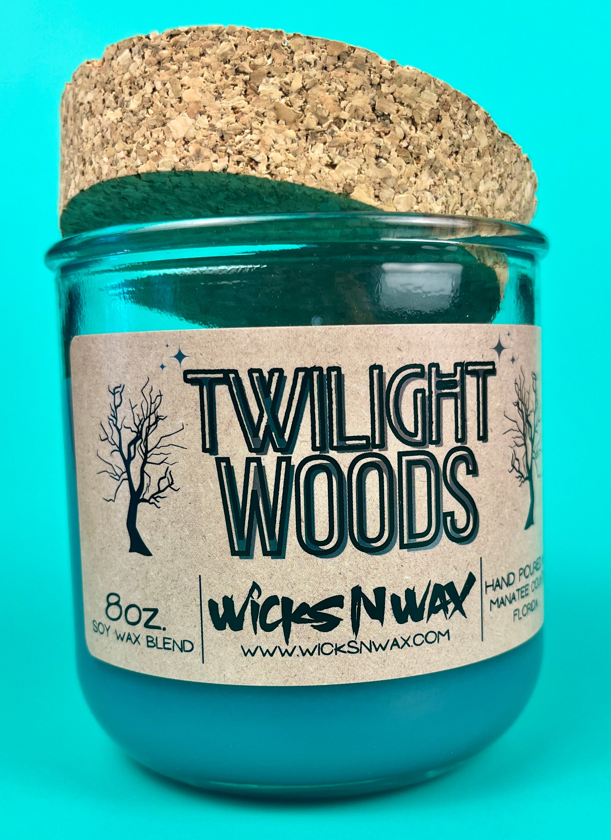 Blue glass candle jar with cork lid and printed Twilight Woods label