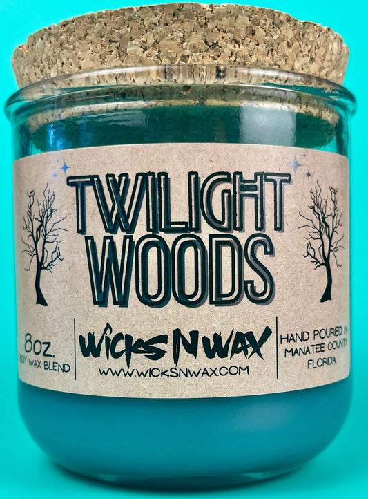 Recycled glass candle in teal jar with WicksNWax Twilight Woods label