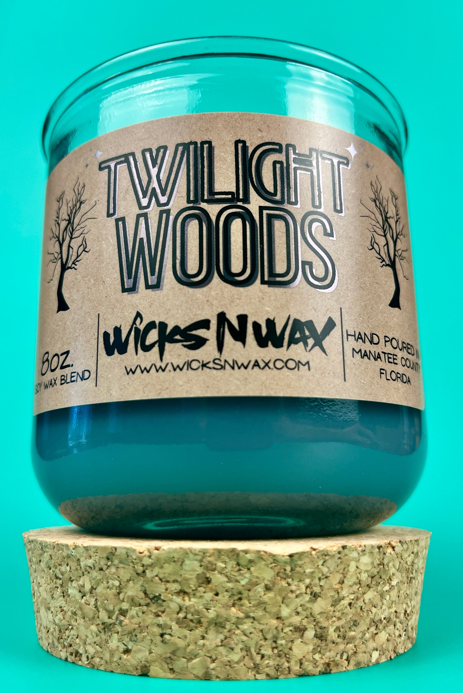 Blue glass candle jar with Twilight Woods label and cork base