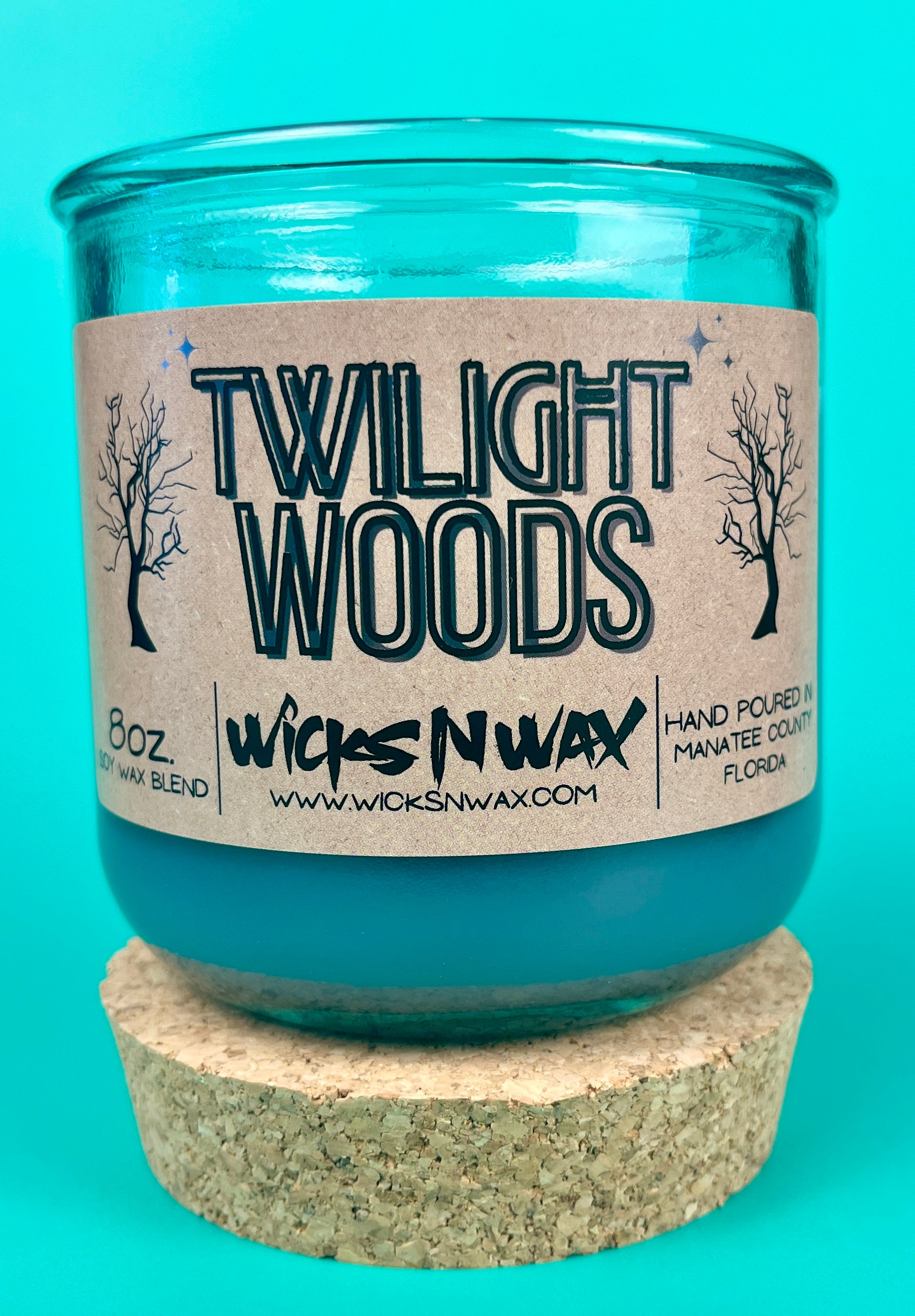 Blue glass candle jar with cork base and Twilight Woods label on front