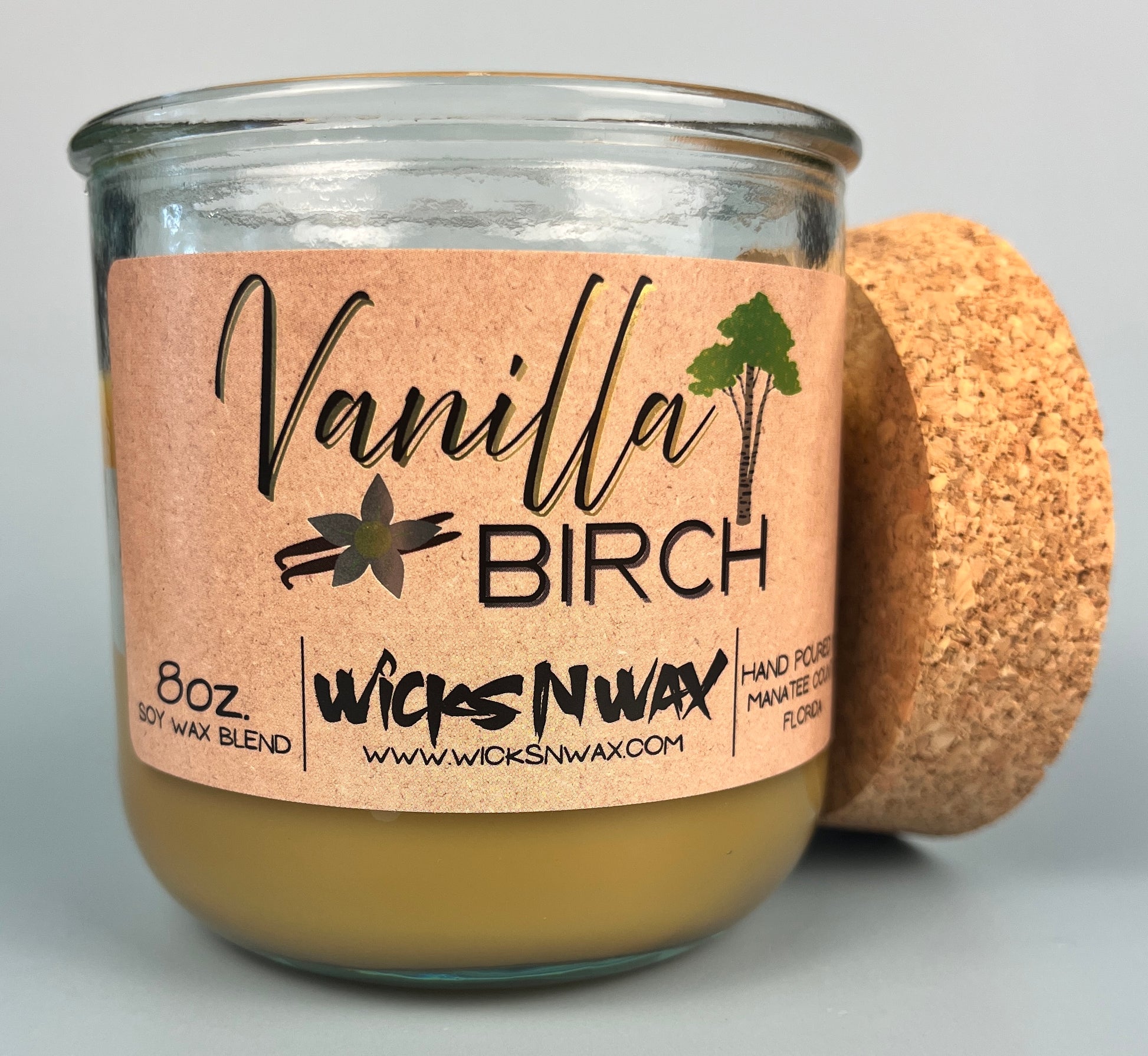 Vanilla Birch recycled glass candle with tan wax, kraft label, and cork lid