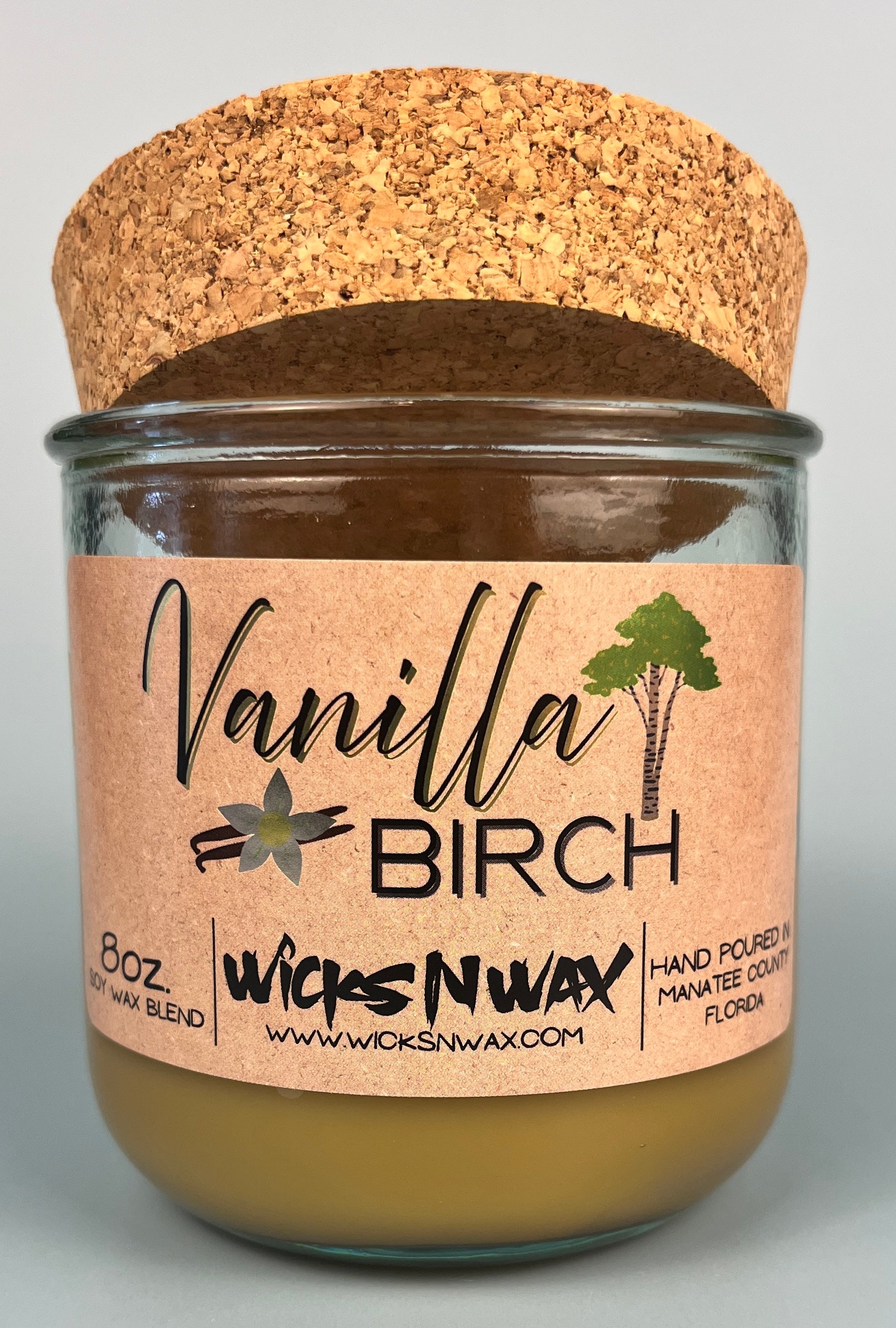 Vanilla Birch recycled glass candle with clear jar, tan wax, and cork lid with kraft label