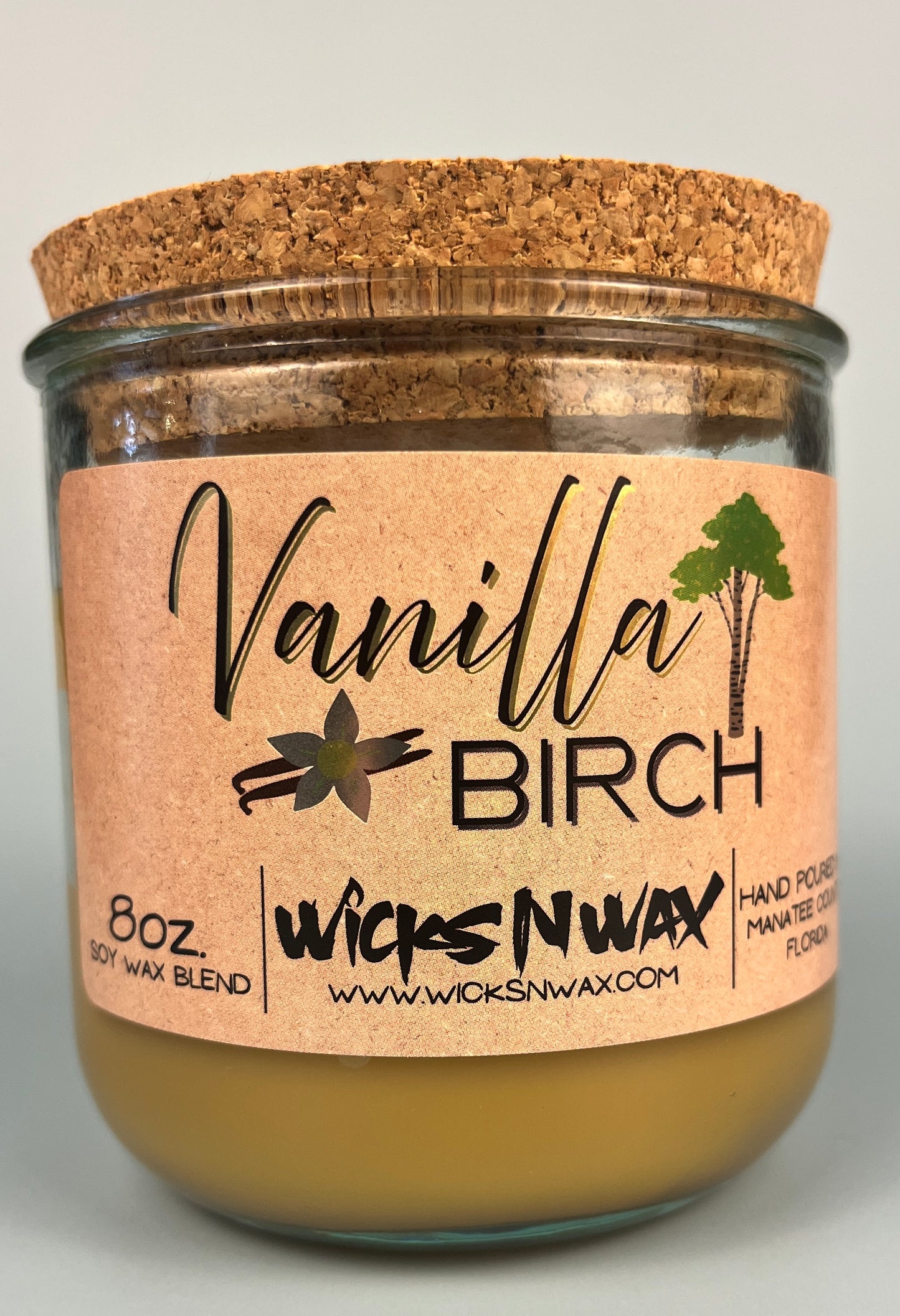 Vanilla Birch recycled glass candle with tan wax and cork lid, clear glass jar, kraft label