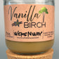 Vanilla Birch recycled glass candle in clear jar with tan wax and cork base, kraft label