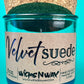 Teal glass candle jar with kraft label, cork lid, and visible wick