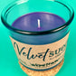 Teal glass candle jar with kraft label and centered wick