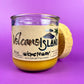 Recycled glass candle jar with Volcano Island label, yellow wax, cork base in side view