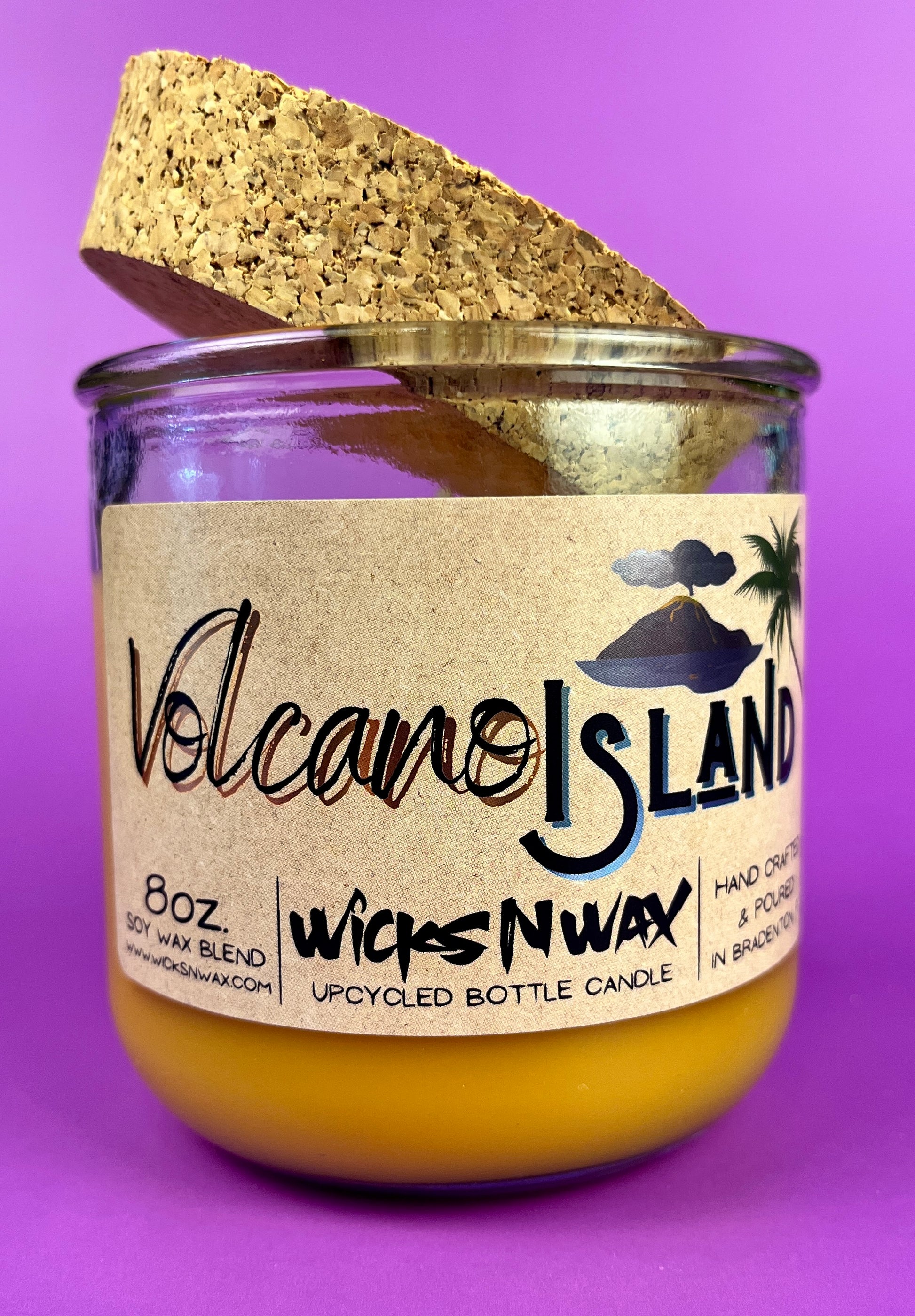 Recycled glass candle jar with Volcano Island label, yellow wax, cork top cover