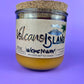 Recycled glass candle jar with Volcano Island label and yellow wax, cork base