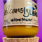 Recycled glass candle jar with Volcano Island label and yellow wax, cork base