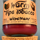 Glass bottle candle with red wax, leaf-and-smoke graphic label, and cork base