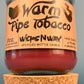 Glass jar bottle candle with red wax and leaf-and-smoke graphic label, on cork base
