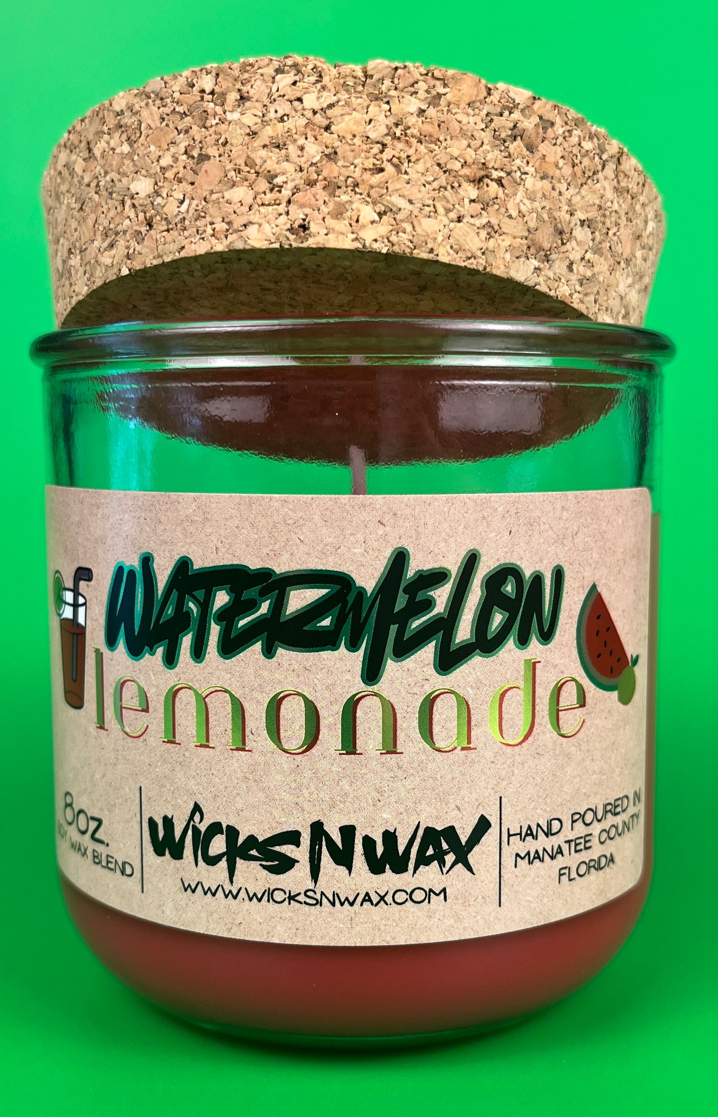 Recycled glass candle jar with red wax, watermelon lemonade label, cork base top view
