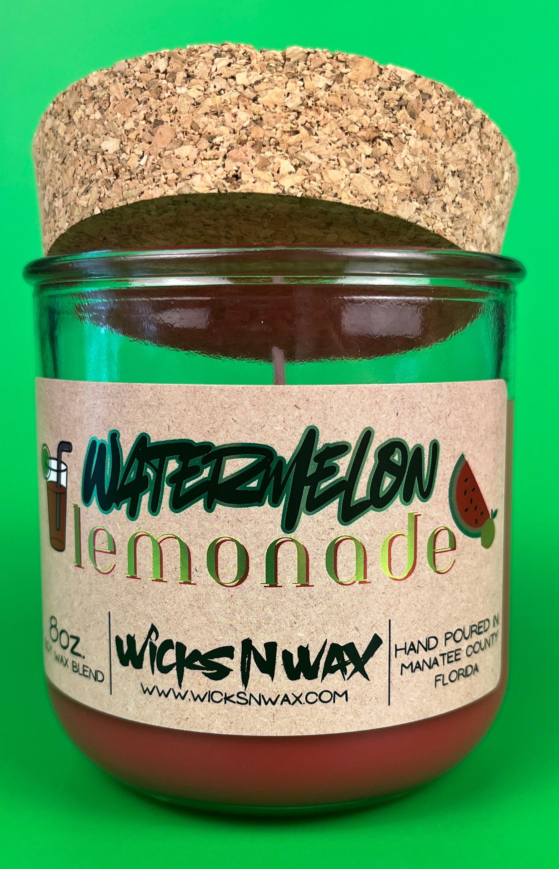 Recycled glass candle jar with red wax, watermelon lemonade label, cork base top view