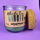Recycled glass candle jar with cork end piece beside it, White Tea & Ginger label.