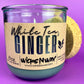 Recycled glass candle jar with cork end piece behind, White Tea & Ginger label.