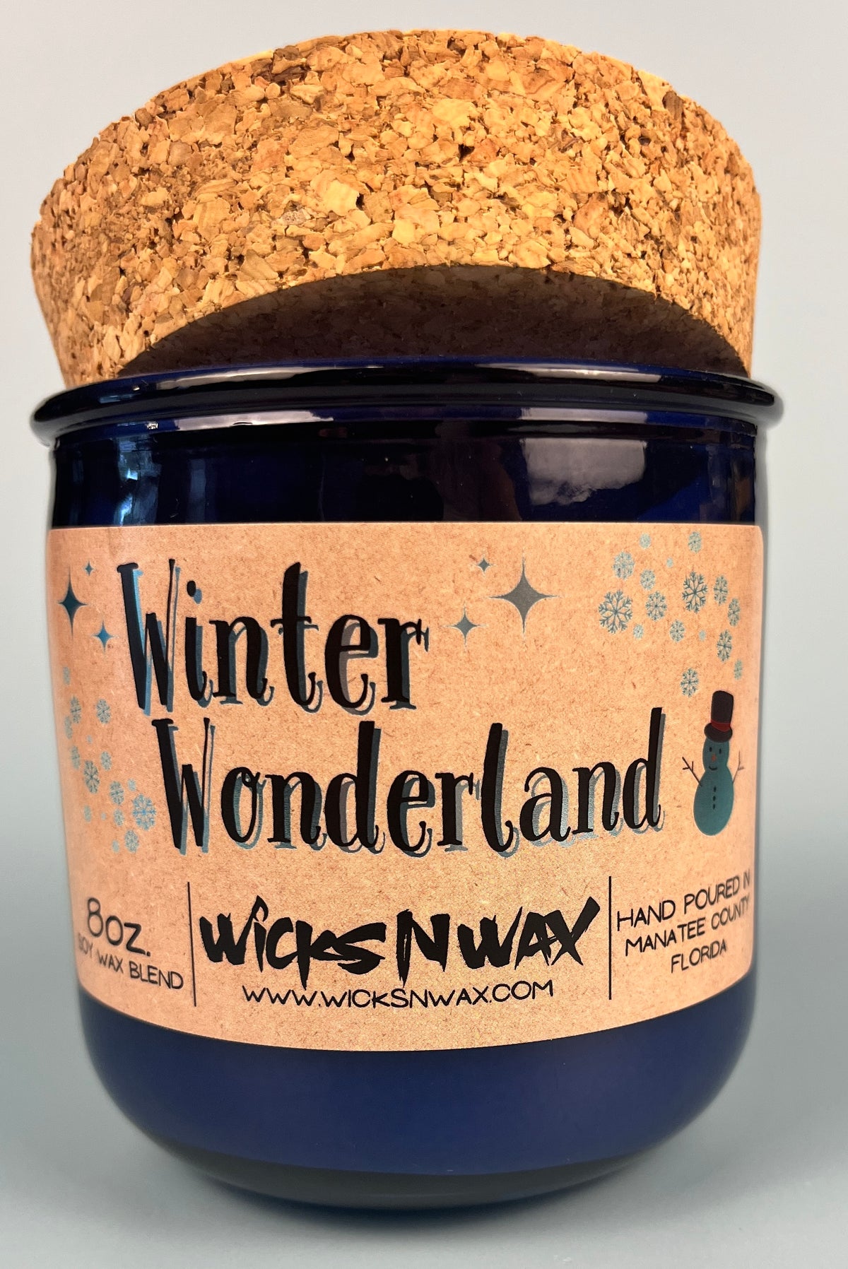 Blue glass candle with cork lid and Winter Wonderland front label