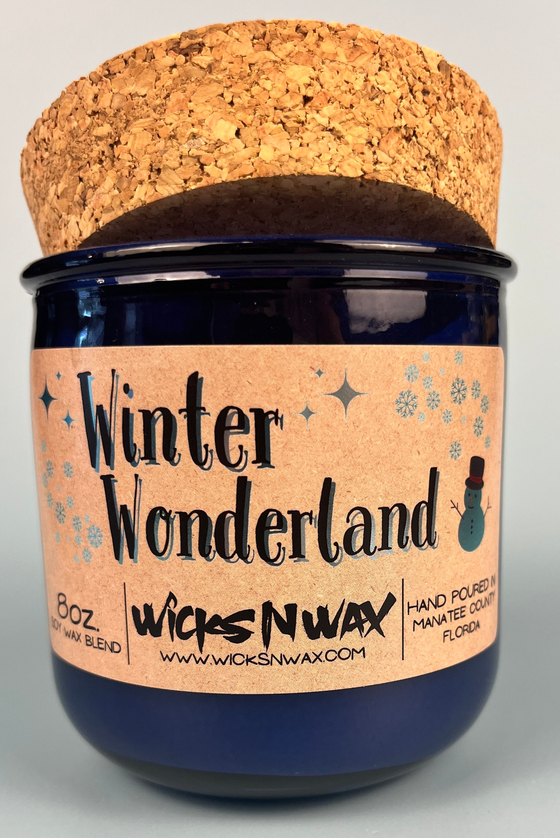 Blue glass candle with cork lid and Winter Wonderland front label