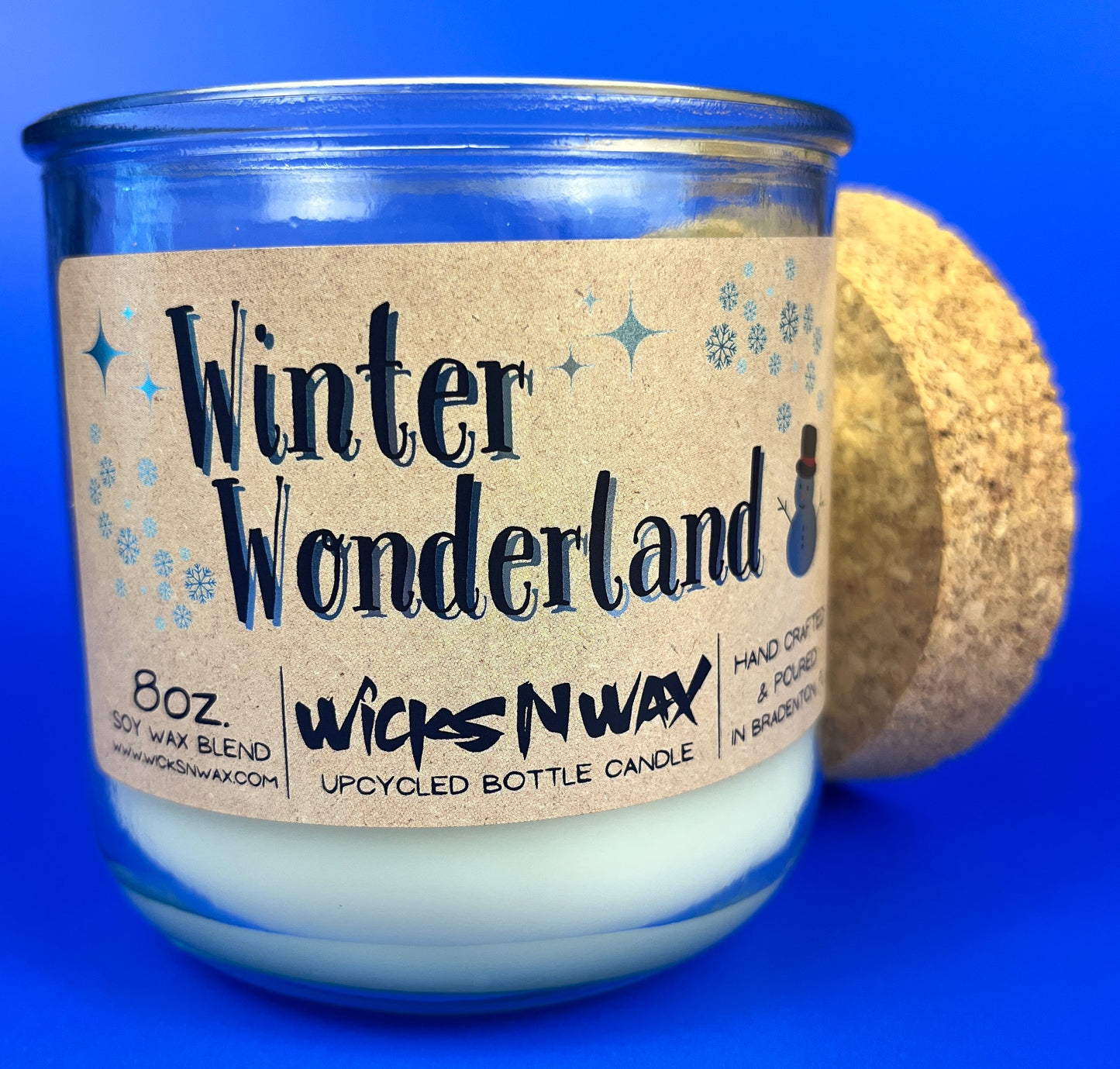 Recycled glass candle jar with Winter Wonderland label on side and cork base