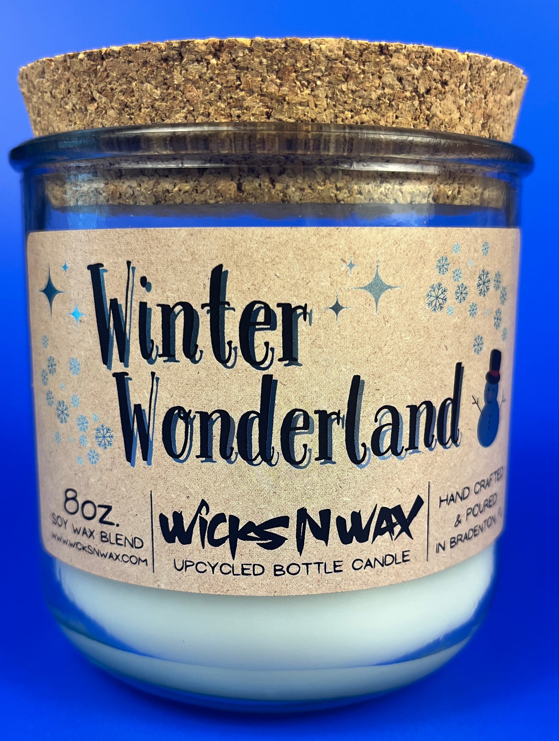 Recycled glass candle with Winter Wonderland label and snowflake icons
