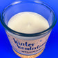 Recycled glass candle top view with visible wick in creamy wax
