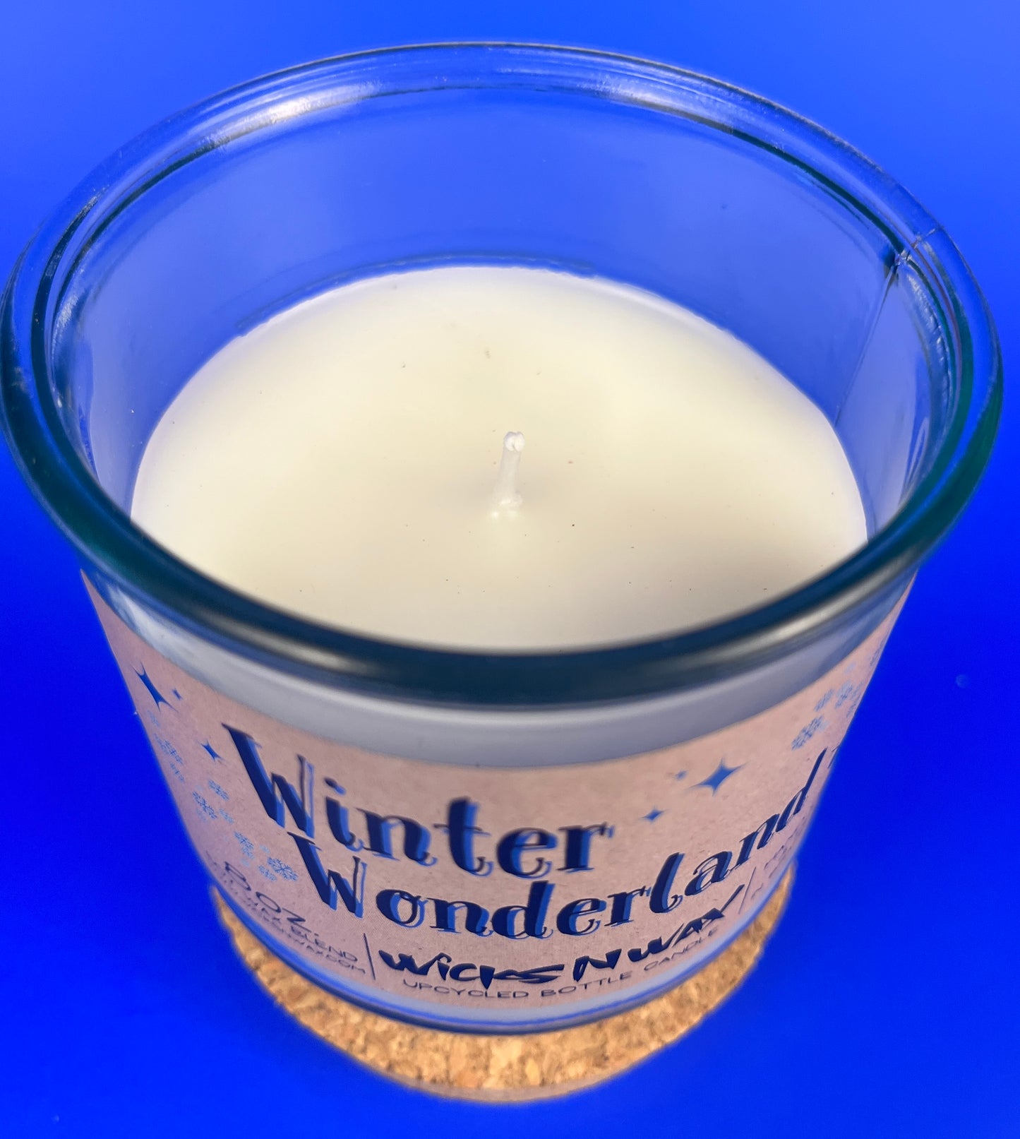 Recycled glass candle top view with visible wick in creamy wax